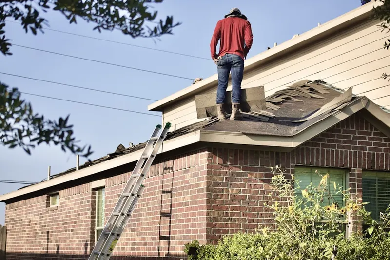 Professional roofer working on a residential roof in La Puente